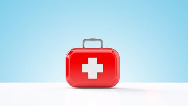First aid kit standing on a blue and white background