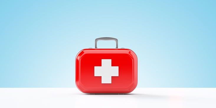First aid kit standing on a blue and white background