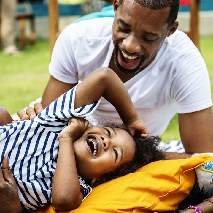 Black family enjoying summer together at backyard