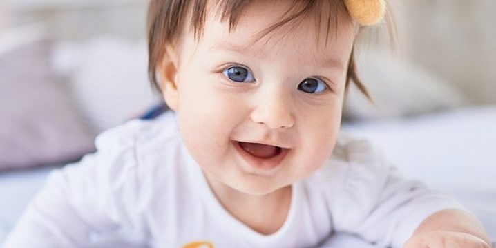 The small baby lies on the bed