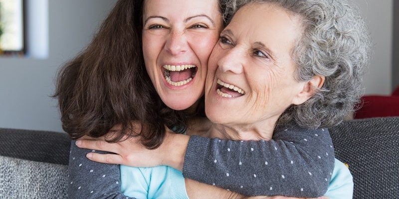 Portrait of happy mid adult woman embracing her senior mother