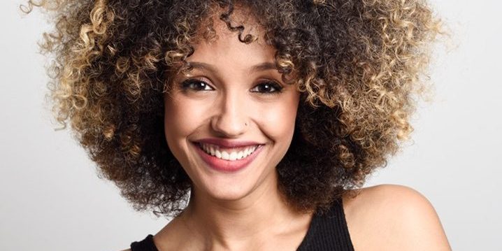 Young black woman with afro hairstyle smiling